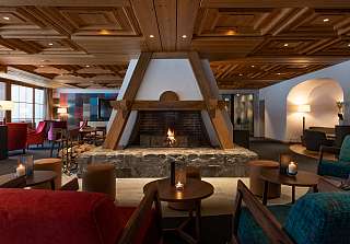 Cosy lounge with open fireplace, candles and seating at Sunstar Hotel Grindelwald