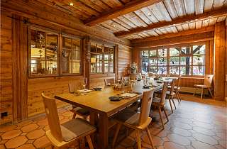 Set table in the Adlerstube restaurant at Sunstar Hotel Grindelwald with wood panelling