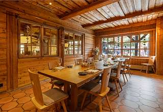Set table in the Adlerstube restaurant at Sunstar Hotel Grindelwald with wood panelling