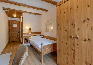 Chambre simple Classic à l'Sunstar Hotel Grindelwald avec lit simple, mobilier en bois et armoire en bois massif
